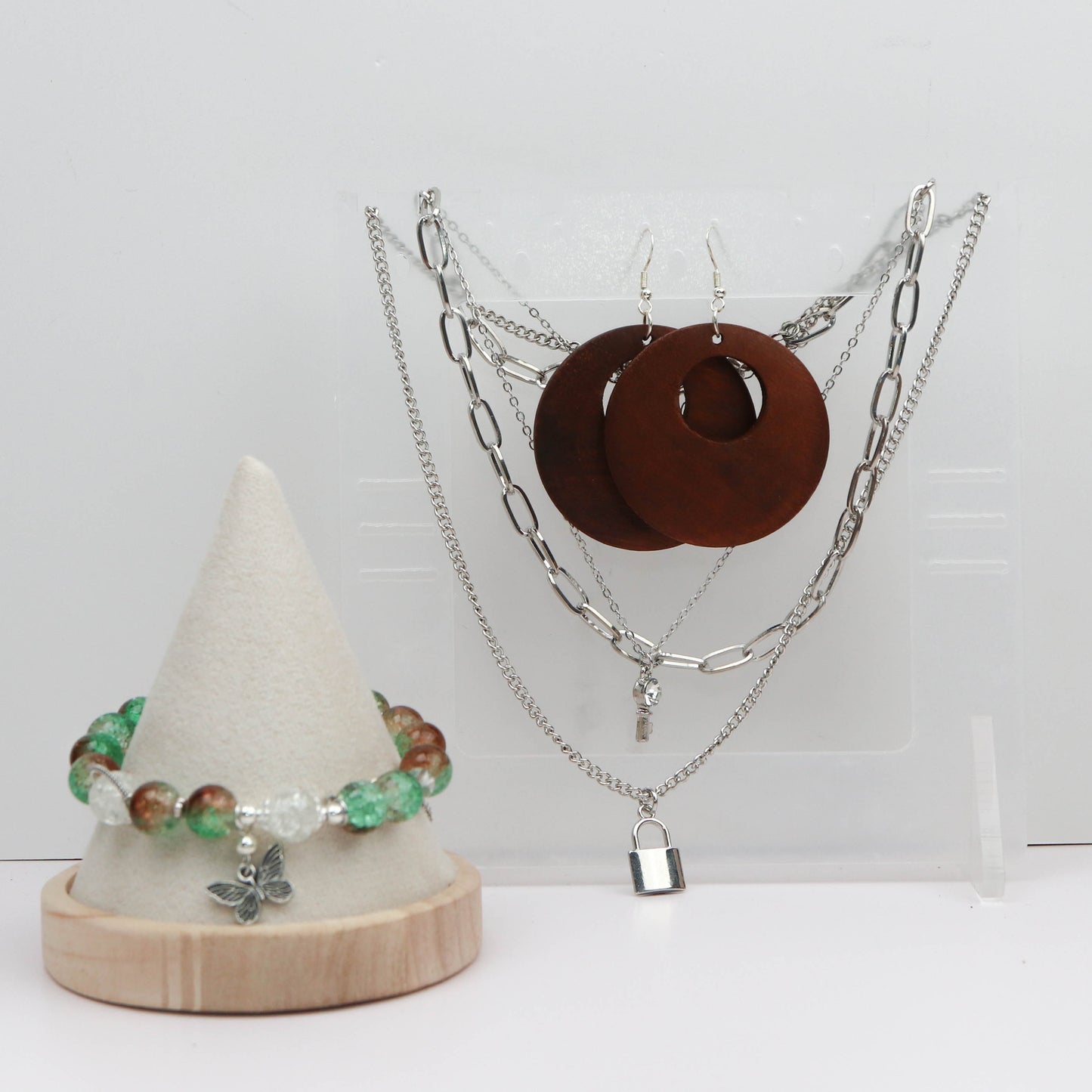 Jewelry set including necklaces, earrings, and a bracelet on a white background
